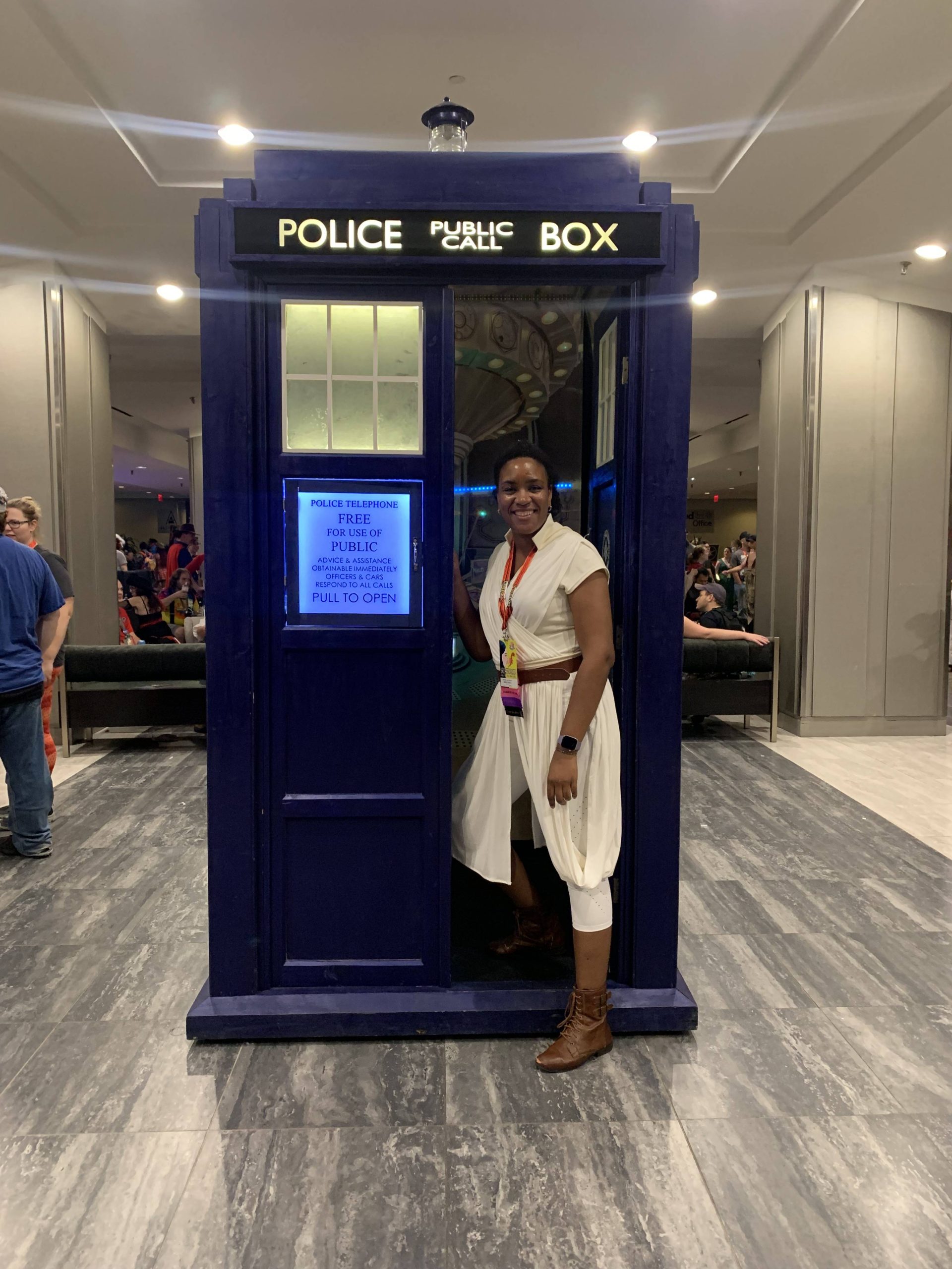 Afro and reno dressed as Rey from Star Wars exiting a Tardis