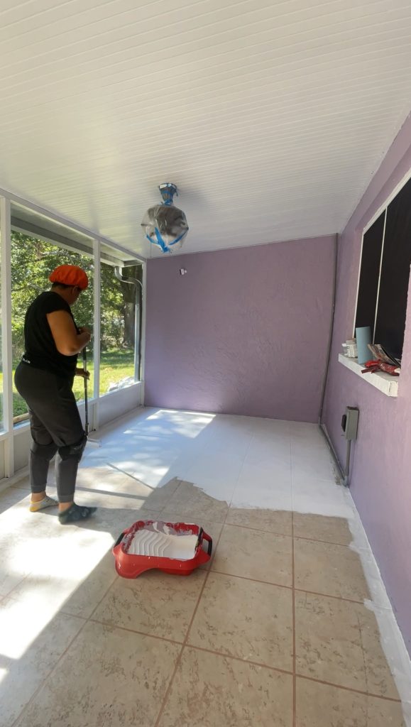 Afro and reno priming the patio floors in preparation for a checkerboard pattern